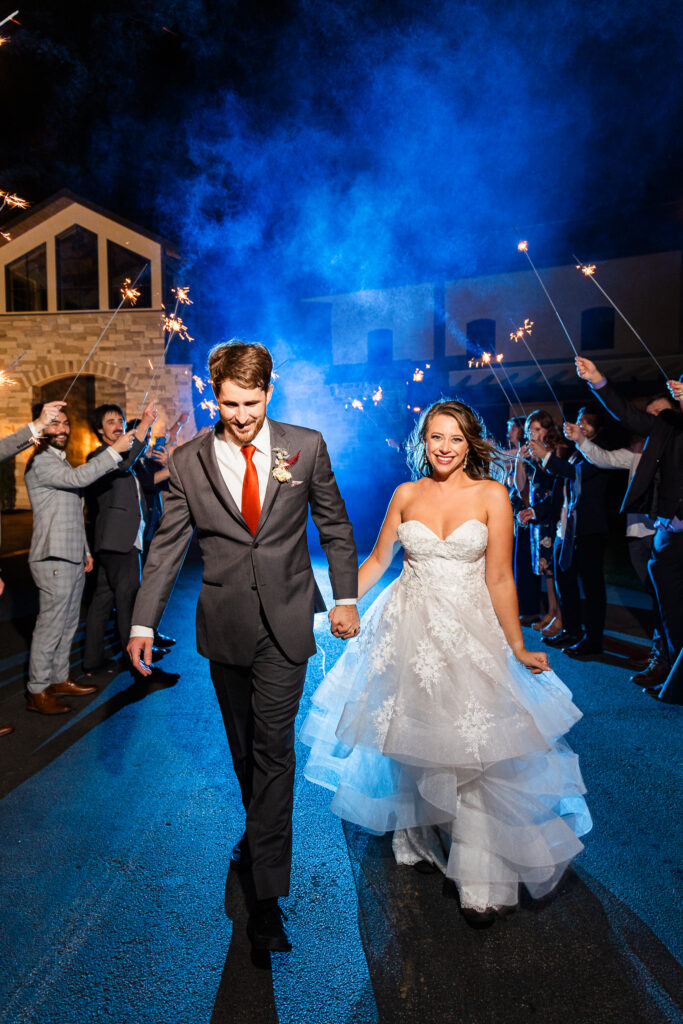 newlyweds make their grand exit through friends and family wielding sparklers, making a colorful getaway